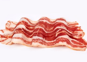 Slices of   pork  smoked  bacon  closeup on white