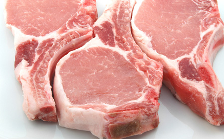 three plump center cut pork chops on white