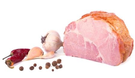 The piece of delicious ham and spices on white background